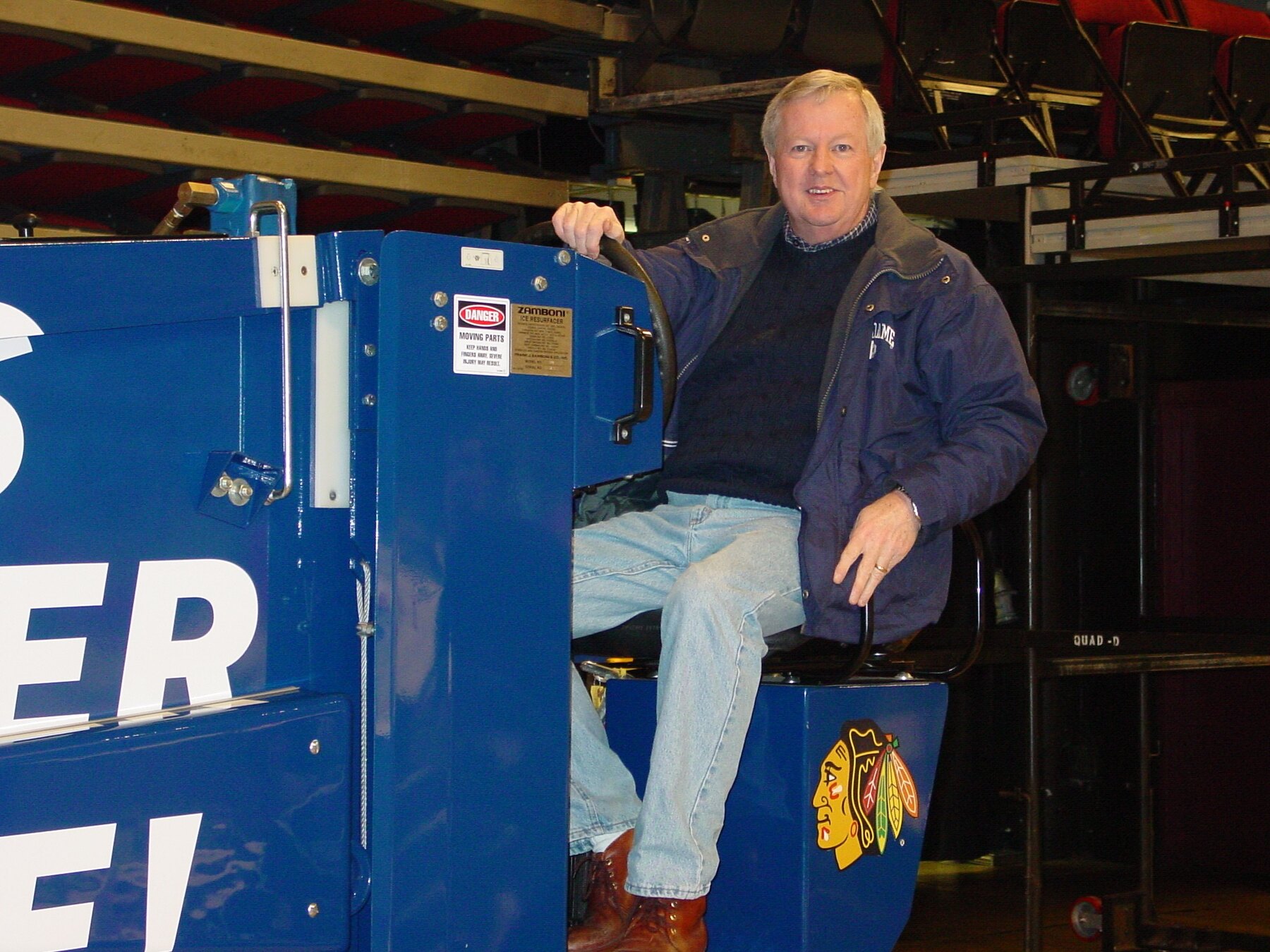 Tom Snyder sitting on a Chicago Blackhawks ice resurfacer