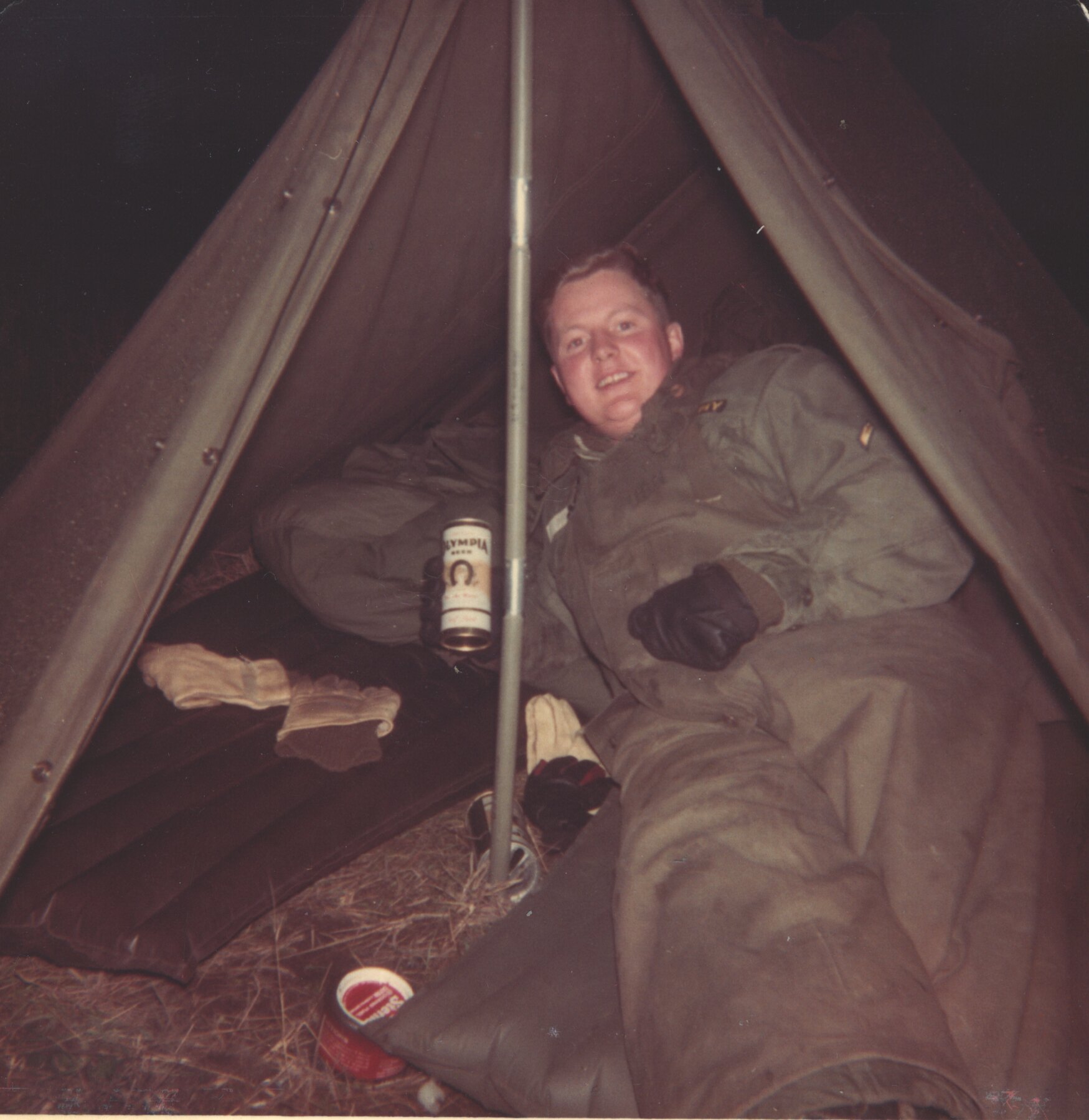 Young Tom Snyder relaxing in a tent during his Army service