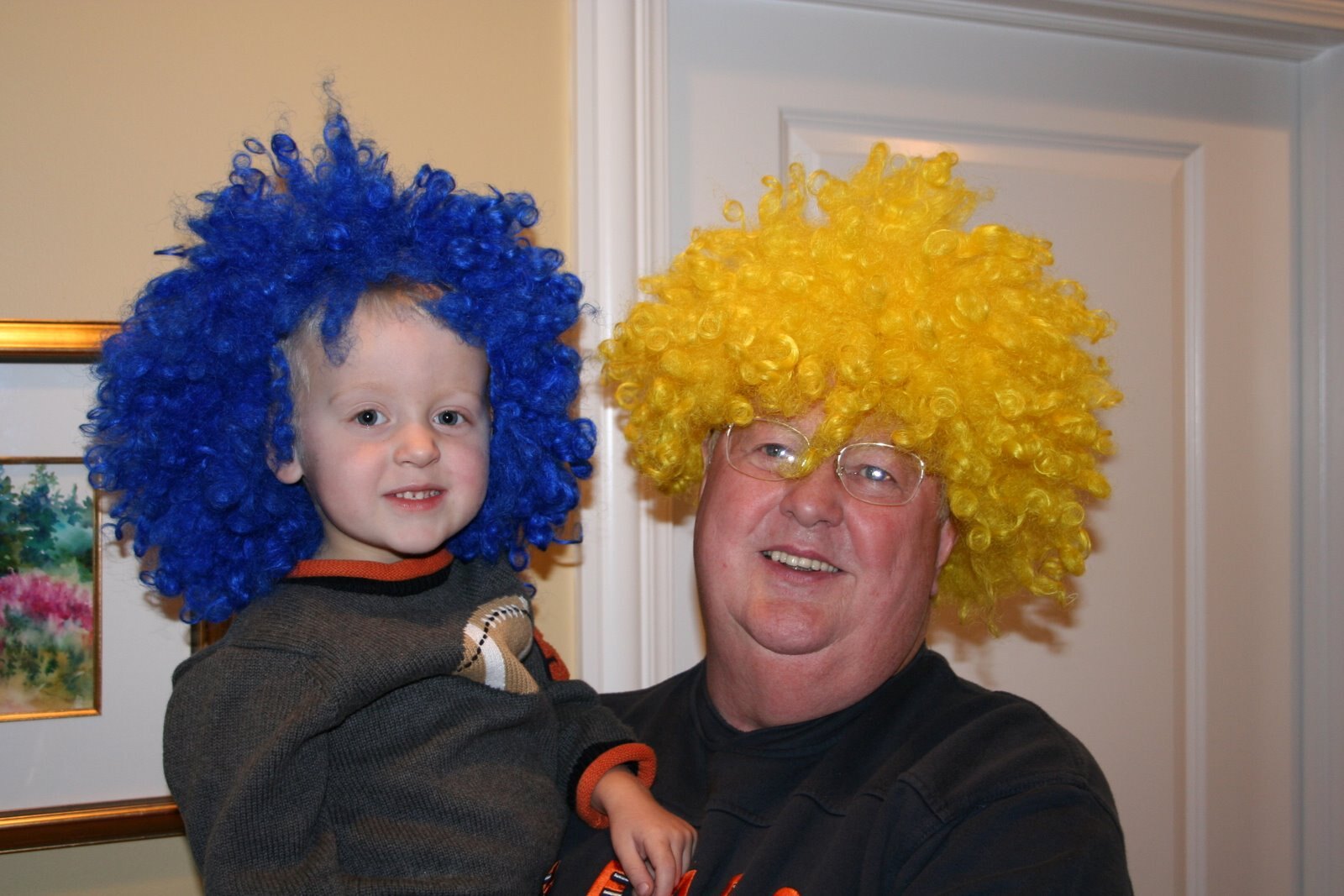 Tom Snyder and a young family member wearing colorful wigs